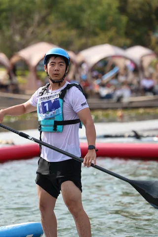 A SUP Polo player standing on a paddleboard and holding a paddle during the tournament.